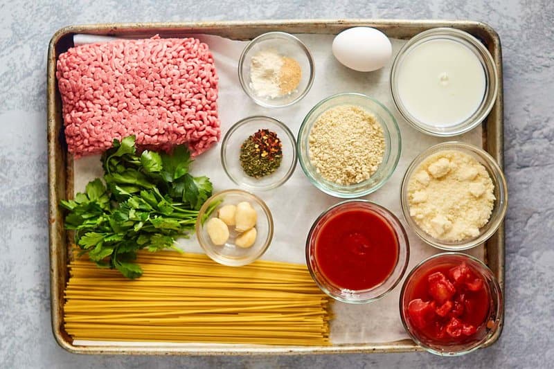 Copycat Olive Garden spaghetti and meatballs ingredients on a tray.