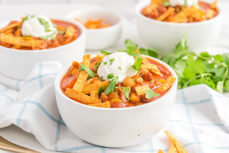 Copycat Panera turkey chili topped with tortilla chips, sour cream, and cilantro.