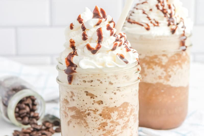 two copycat Starbucks mocha frappuccino drinks with whipped cream.
