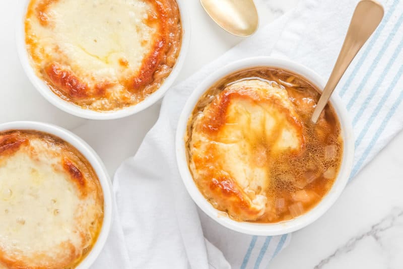 overhead view of bowls of copycat TGI Friday's French onion soup.