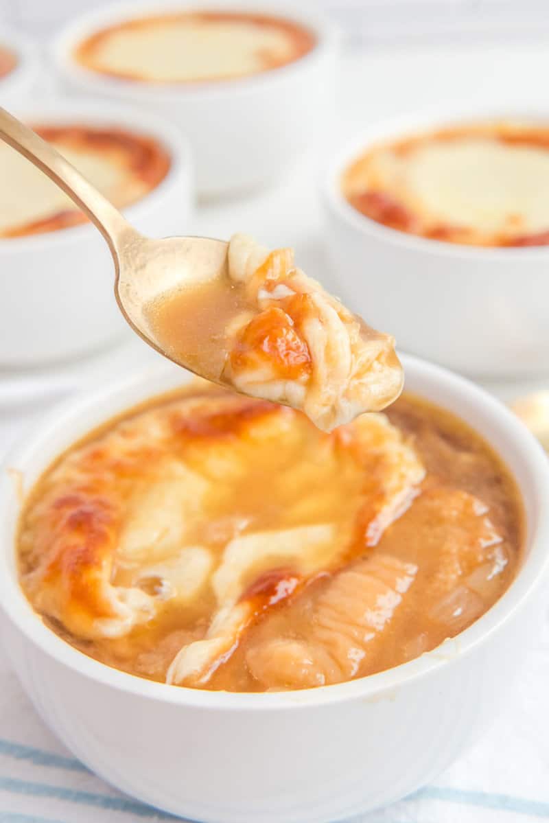 a bowl of copycat TGI Friday's French onion soup in a bowl and on a spoon.