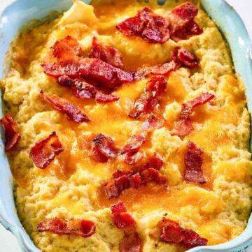 Twice baked cauliflower in a blue casserole dish.