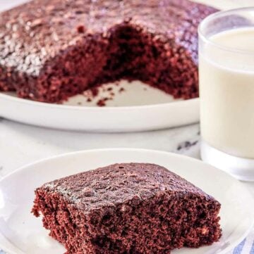 wacky cake slice on a plate in front of the cake.