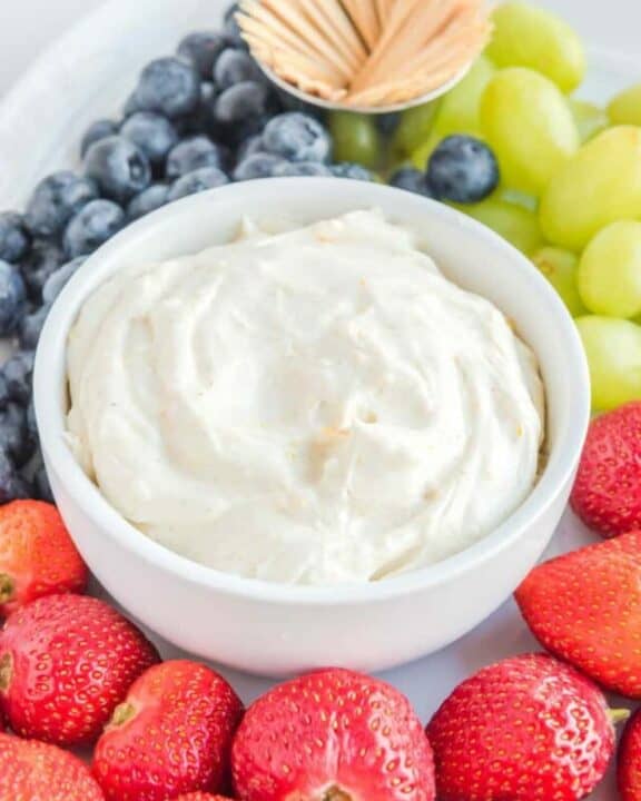 Cream cheese fruit dip, strawberries, grapes, blueberries, and toothpicks.