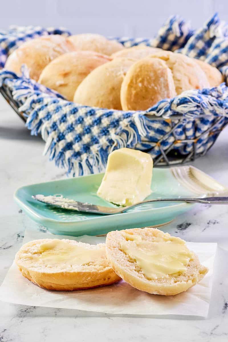 Angel biscuits in a basket and one with butter.