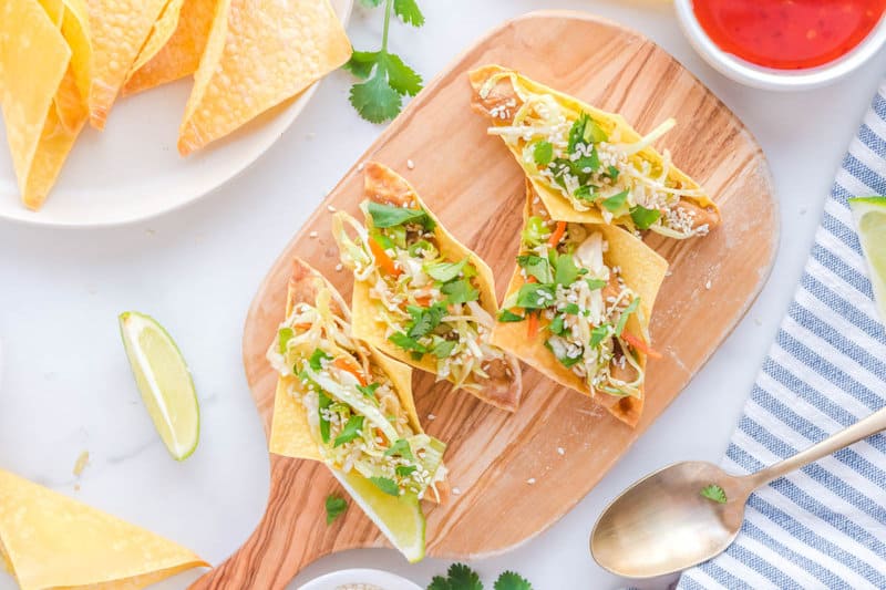 Overhead view of copycat Applebee's chicken wonton tacos on a wood board.