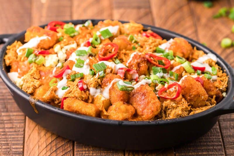 copycat Buffalo Wild Wings Buffalo chicken tots in a black serving dish.