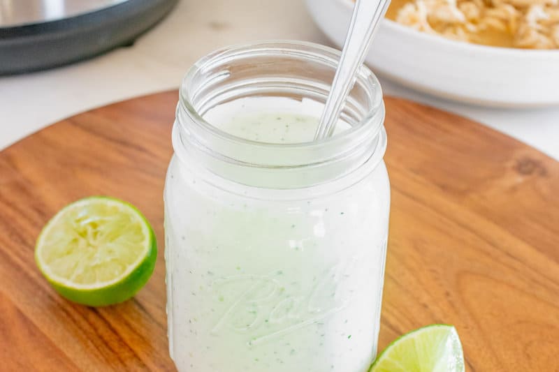 Copycat Cafe Rio creamy tomatillo dressing in a mason jar.