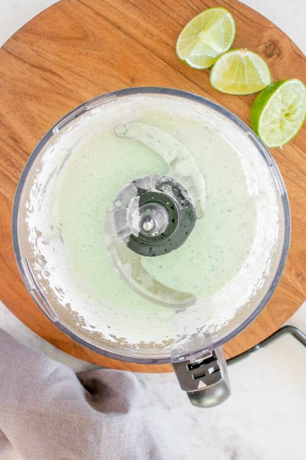 Blended tomatillo dressing in a food processor.