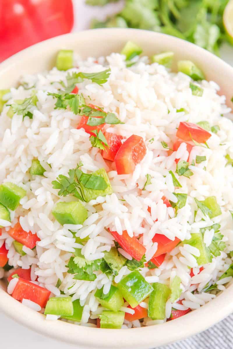 Closeup of cilantro rice with bell peppers in a bowl.
