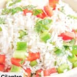 Cilantro rice with bell peppers in a white bowl.