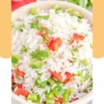 Closeup of cilantro rice in a white bowl.