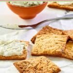 Homemade crackers scattered on parchment paper.