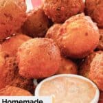 Homemade southern hush puppies and sauce in a basket.