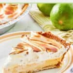 A slice of key lime meringue pie on a white plate.