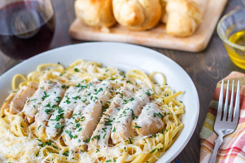 Copycat Olive Garden grilled chicken alfredo with pasta on a plate.