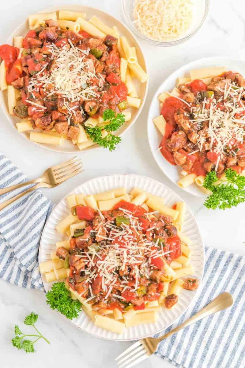 Overhead view of copycat Olive Garden Neapolitan ziti on three plates.