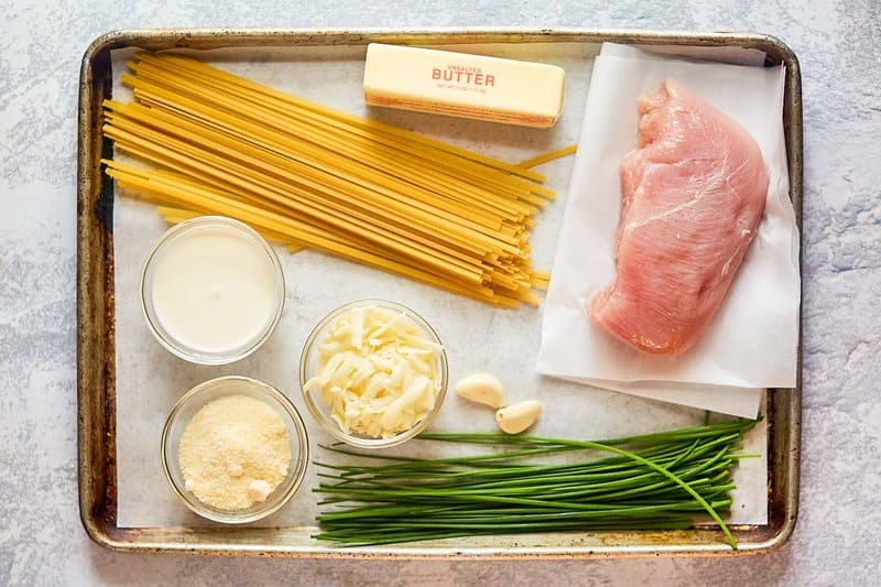 One pot chicken alfredo ingredients on a tray.
