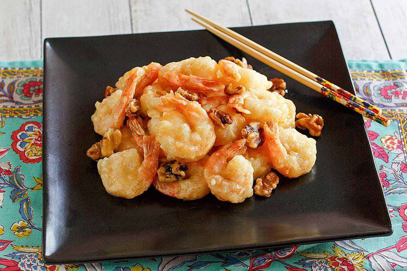 Copycat Panda Express honey walnut shrimp and chopsticks on a plate.