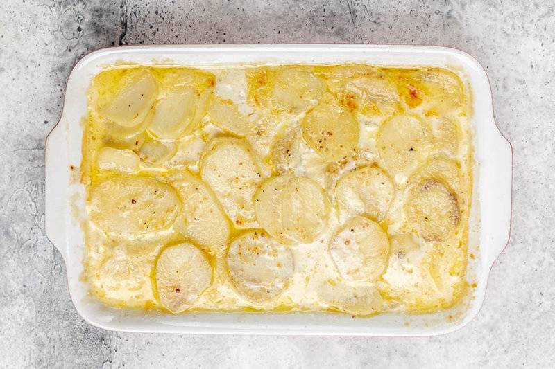 Scalloped potatoes without cheese in a baking dish.