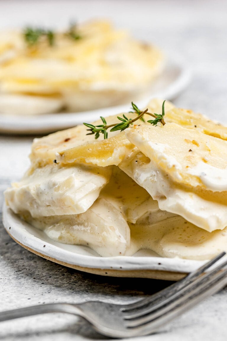 Scalloped potatoes without cheese on plates.