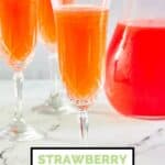 Strawberry mimosa in a pitcher and champagne flutes.
