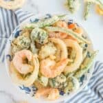 Overhead view of homemade tempura batter fried vegetables and shrimp.