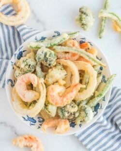 Overhead view of homemade tempura batter fried vegetables and shrimp.