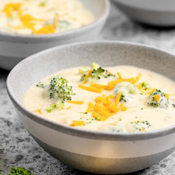 Three cheese broccoli soup in three bowls.