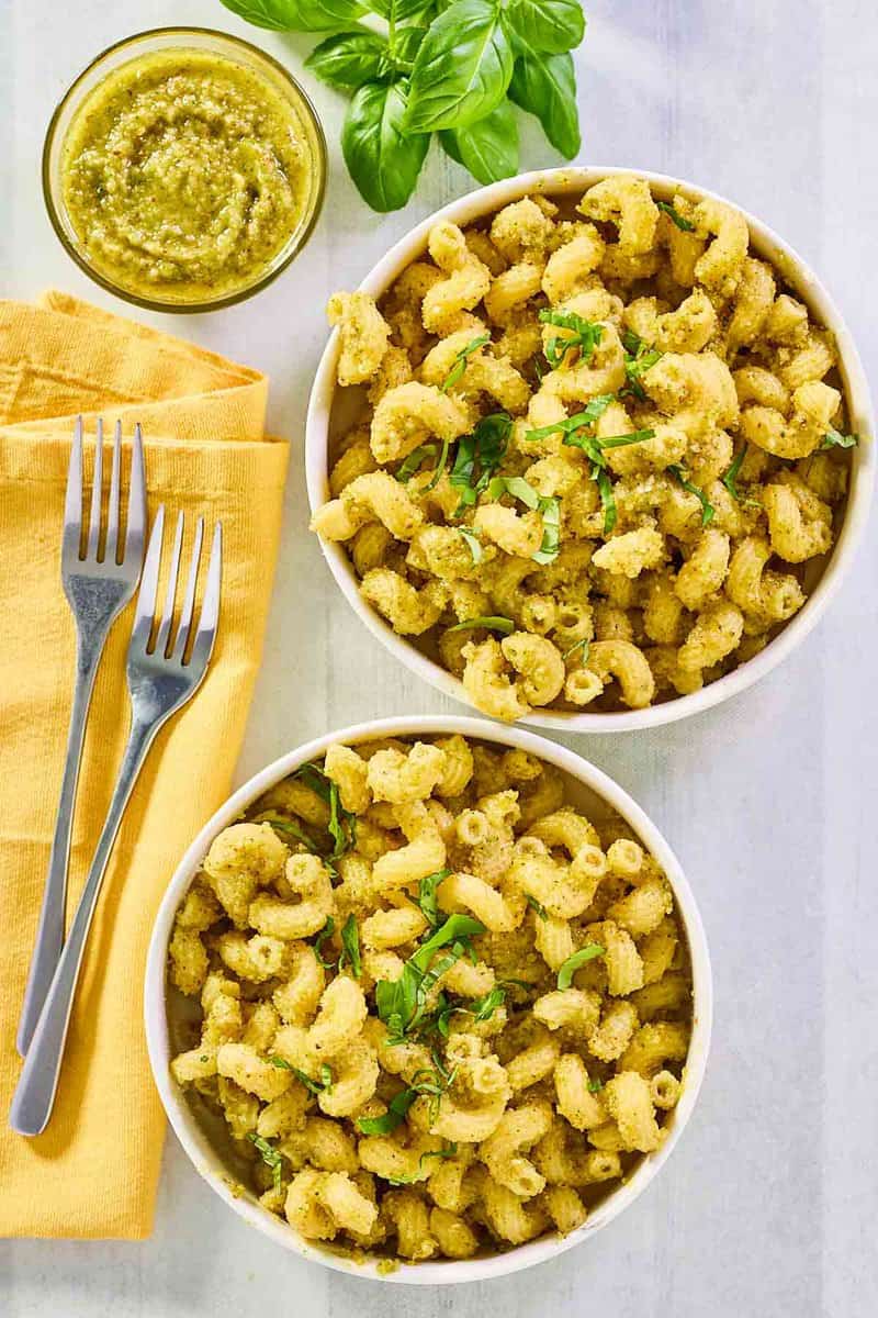 Overhead view of copycat Alonti pecan pesto pasta in two bowls.