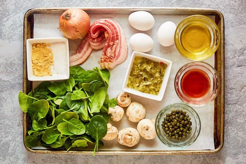 Copycat Chart House spinach salad and dressing ingredients on a tray.