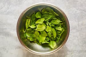 Baby spinach leaves in a bowl.