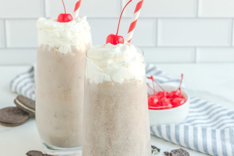 Copycat Chick Fil A cookies and cream milkshakes with whipped cream and a cherry.