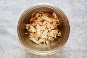 Pieces of cooked chicken in a bowl.