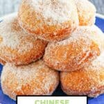 Homemade Chinese sugar donuts stacked on a plate.