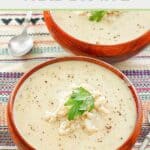 Creamy crab bisque in two wood bowls.