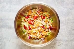 Frito taco salad ingredients in a large bowl.