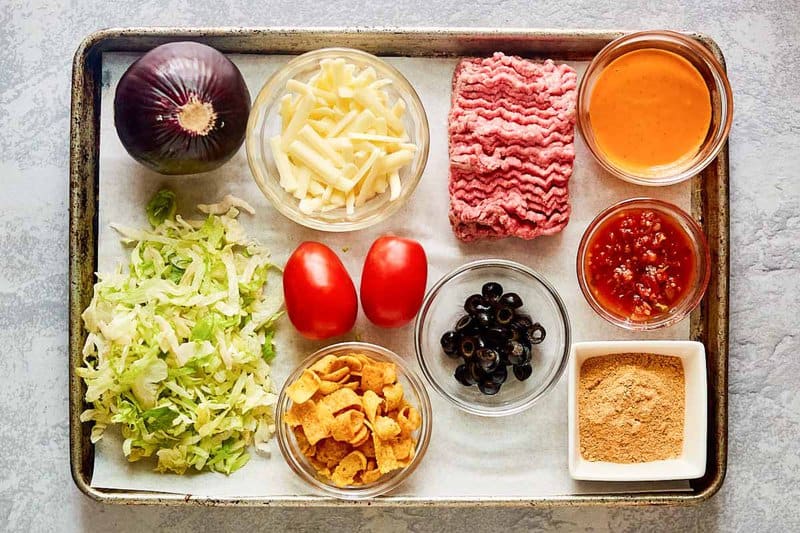 Frito taco salad ingredients on a tray.