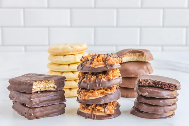 Five different homemade Girl Scout cookies in stacks.
