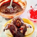 Homemade hot fudge sauce in a glass bowl and on top of ice cream.