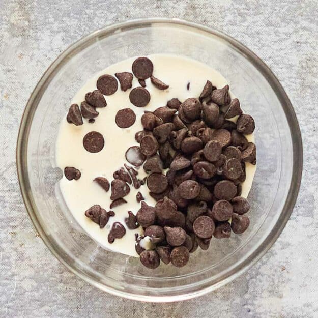 Chocolate chips and cream in a bowl.