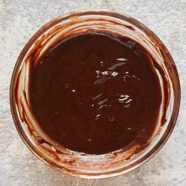 Overhead view of homemade hot fudge sauce in a bowl.