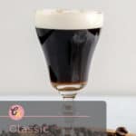 Irish coffee in a stem glass.