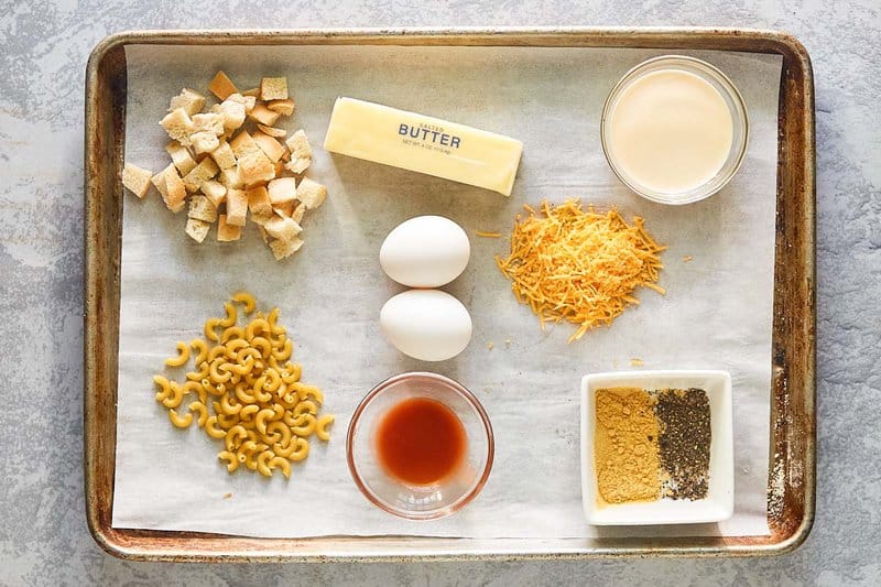 Mac and cheese with bread crumbs ingredients on a tray.