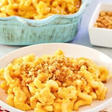 Homemade mac and cheese with bread crumbs in a baking dish and on a plate.