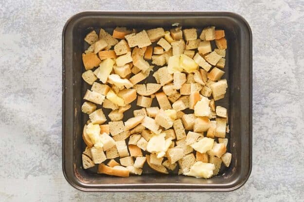 Bread pieces in a baking dish.