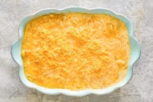 Mac and cheese in a baking dish after being stirred during baking.