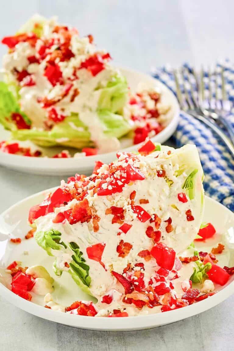 Maytag buttermilk blue cheese dressing and chopped tomatoes on iceberg lettuce wedges.