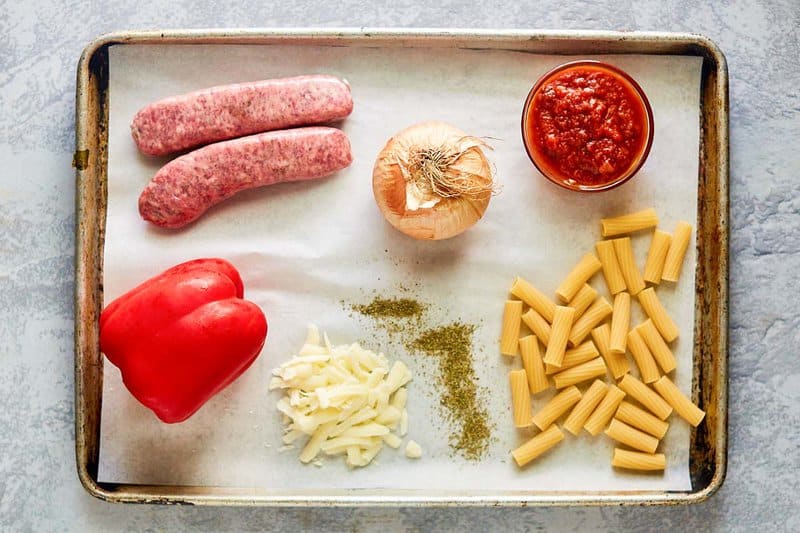 One pot sausage pasta ingredients on a tray.