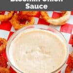 Copycat Outback Steakhouse bloomin onion sauce in a bowl and onion rings on parchment paper.